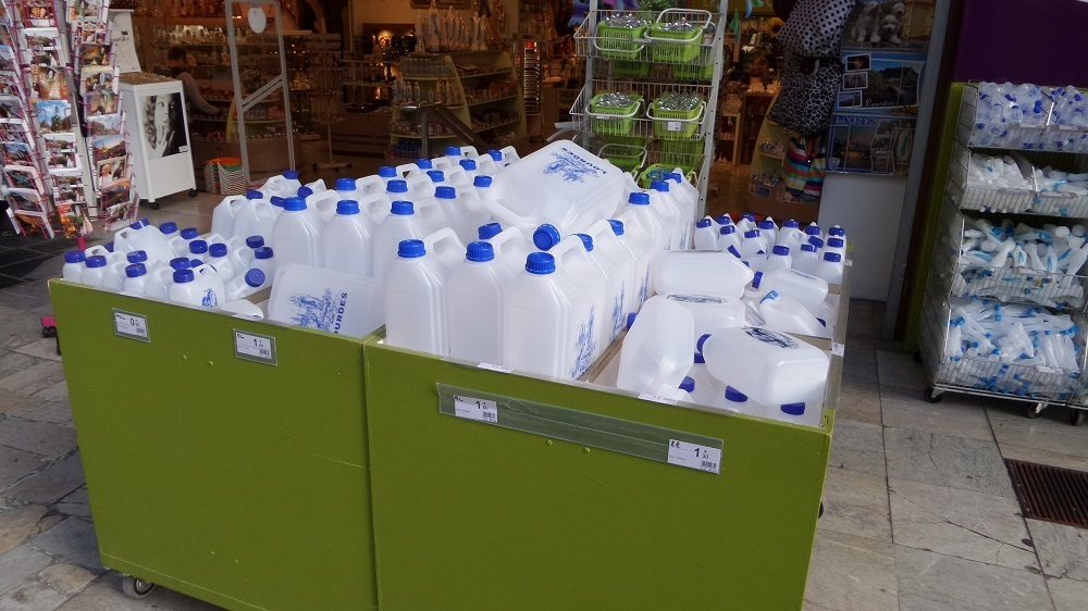 Plastic bottles for gathering take-away holy water at Lourdes. Source: Village to Villa